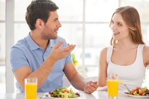 Couple having breakfast. Beautiful young couple sitting together at the breakfast table and talking photo