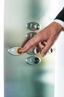 Man pushing button. Close-up of male hand pushing button of elevator photo