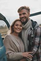 Pure feelings. Beautiful young couple embracing and smiling while standing outdoors photo