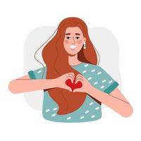 the red-haired girl smiles and shows her heart with her hands. A woman in a T-shirt loves and shows a gesture on a white background vector