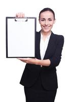 Cope space on her clipboard. Businesswoman demonstrating empty paper on a clipboard photo