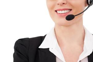 Female operator. Cropped image of confident mature customer service representative in headset smiling while isolated on white photo