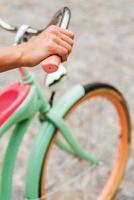 Riding bike. Close-up of woman riding a vintage bicycle photo