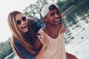 Unleashed fun. Beautiful young couples spending carefree time while standing on the pier photo