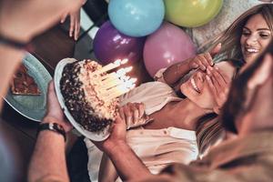 Surprise for her smiling while enjoying a party photo