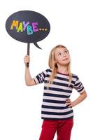 Maybe is a good answer. Girl holding speech bubble and looking up while standing against white background photo