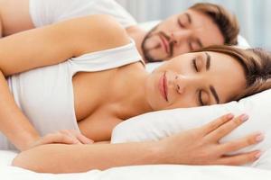 Sweet dreams. Beautiful young loving couple sleeping together in bed photo