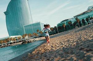 Training for the big day. Full length rear view of beautiful young woman in sports clothing jogging while exercising outdoors photo