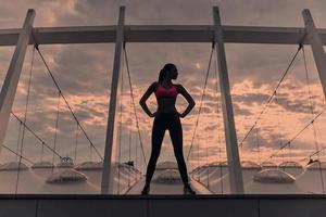 Feeling the freedom. Full length of modern young woman in sports clothing keeping hands on hips and looking away while standing outdoors photo