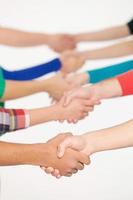 Shaking hands. Close up of people handshaking while standing in a row photo