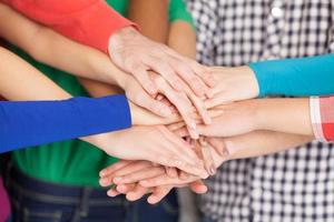 We are strong when we together. Close-up of many hands clasped together photo