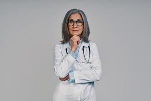 Mature beautiful female doctor looking at camera and smiling photo