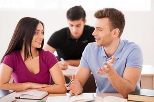 Studying is fun. Two confident students together while sitting at the classroom photo