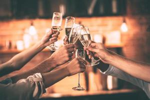 Cheers Group of people cheering with champagne flutes with home interior in the background photo