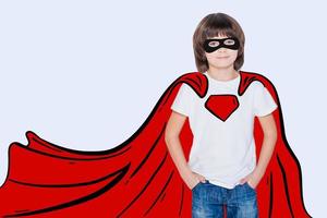 Like a hero. Cheerful boy holding hands in pockets and looking like superhero in his drawn cape while standing against white background photo