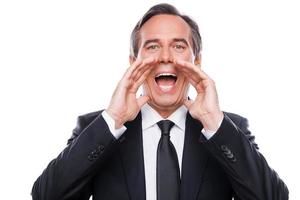 Announcing good news. Happy young man in formalwear shouting while looking at camera and standing isolated on white background photo