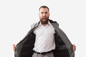 Freedom.  Handsome young bearded man screaming and looking at camera photo