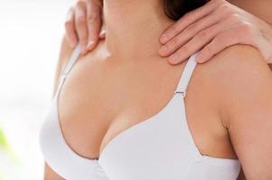 Massaging her tired shoulders. Close-up of man massaging his girlfriend shoulders photo