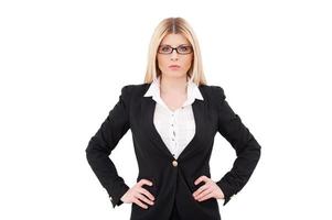 Confident and successful businesswoman. Confident mature businesswoman holding hands on hip and looking at camera while standing isolated on white photo