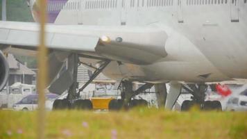 Close up engines widebody airplane at start runway before departure from Phuket airport video