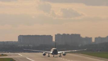 Commercial jet plane speed up before takeoff, rear view. Commercial aircraft flying away. Tourism and travel concept video