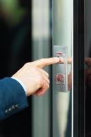 He is going up. Cropped image of male hand pushing the elevator button photo