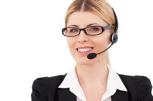 Always ready to help you. Confident mature customer service representative in headset looking at camera and smiling while standing isolated on white photo