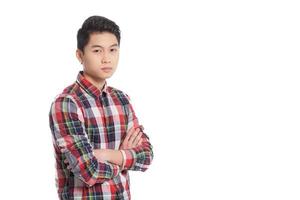 Confident look. Smiling Chinese teenage boy keeping arms crossed and smiling while standing isolated on white photo