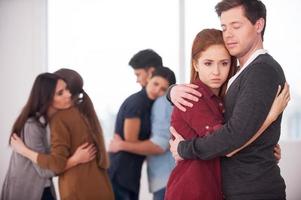 People we can trust. Group of depressed people hugging each other photo