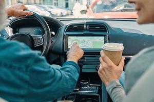 Close up rear view of active senior couple using global positioning system photo