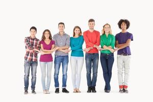 Together we are strong. Full length of cheerful multi-ethnic people holding hands while standing in a row photo