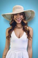 Portrait of beautiful young woman in elegant hat looking at camera and smiling photo