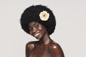 Portrait of beautiful young African woman looking at camera and smiling photo