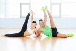 Healthy and fresh. Sporty couple exercising at the fitness gym photo