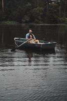 Life can not be better. Beautiful young couple embracing and smiling while enjoying romantic date on the lake photo