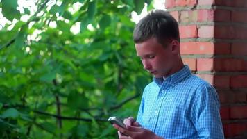 jongen met een touch screen telefoon Aan de straat video