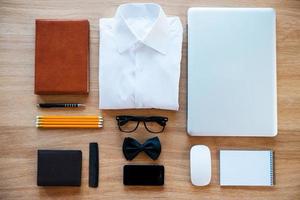 Nerd collection. Top view of clothing and diverse personal accessory for nerd laying on the wooden grain photo