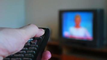 human hand changes the channels on the TV remote control video