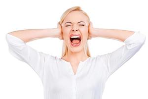 I hate this sound Depressed mature woman keeping eyes closed and covering ears with hands while standing against white background photo