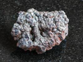 rough Goethite stone on black photo