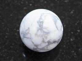 bead from Howlite gemstone on dark background photo