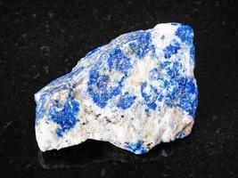 raw Lazurite Lapis Lazuli stone on black photo