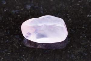 polished rose quartz gemstone on dark background photo