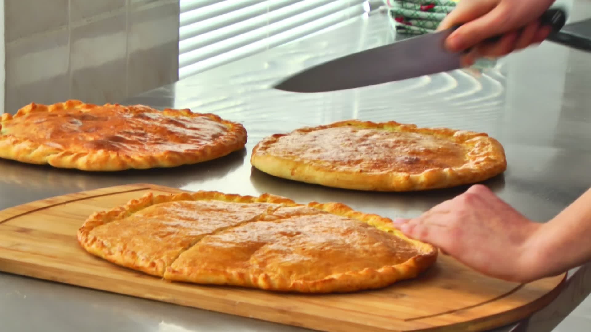 chef knife cuts pastries on the table 13551663 Stock Video at Vecteezy