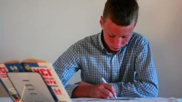 Boy studying with books video