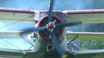 AN 2 aircraft stands at the airport before takeoff and the engine warms video