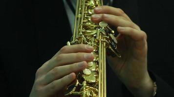 man's hands playing a wind instrument