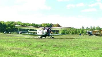 AN 2 aircraft stands at the airport before takeoff and the engine warms video