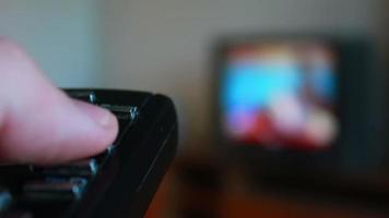 human hand changes the channels on the TV remote control video