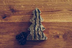 Handmade tree. Close-up top view of handmade Christmas tree lying on the rustic wooden grain photo